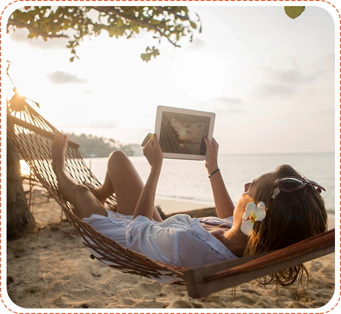 A woman laying in a hammock on the beach