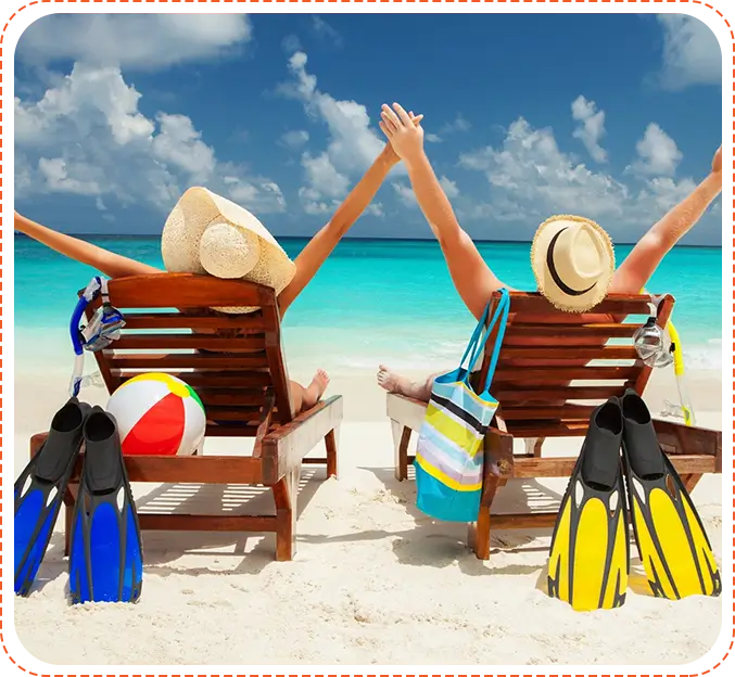 Two people sitting on a beach chairs with their arms raised.