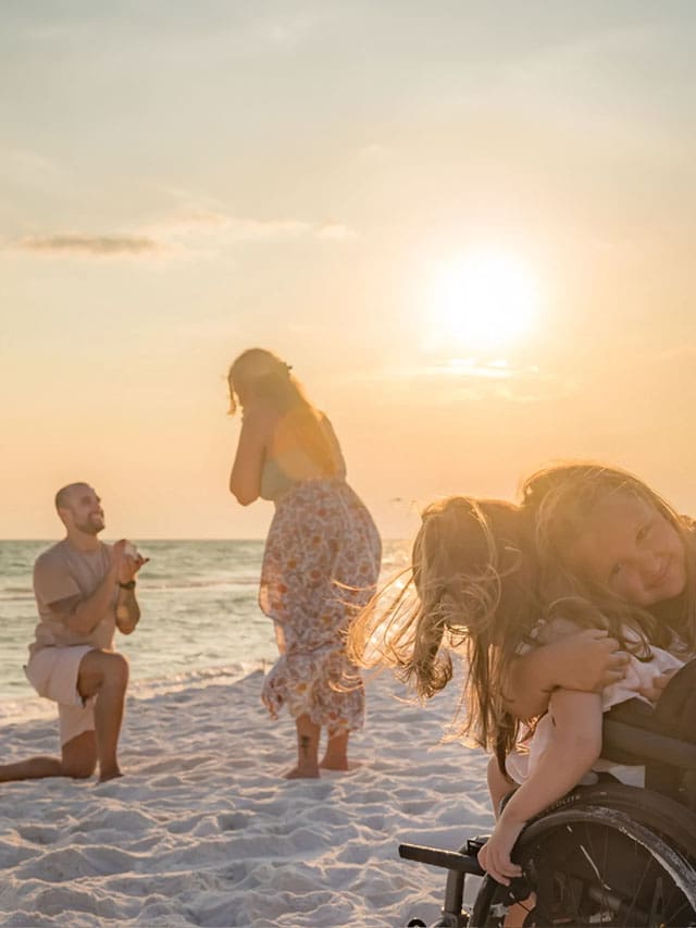 Family on the beach at sunset.